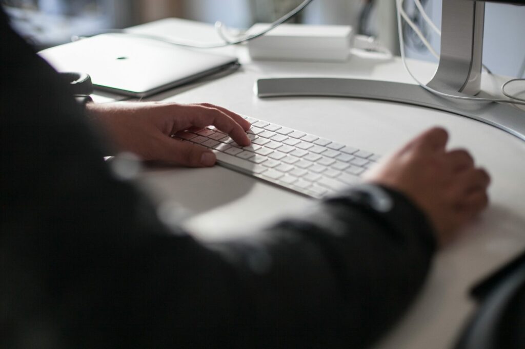 person typing on a keyboard