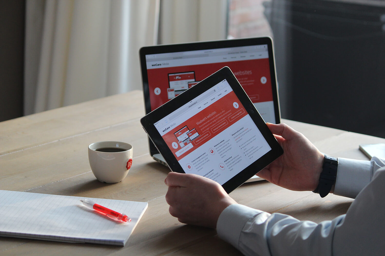 The same website shown on an iPad and a laptop.