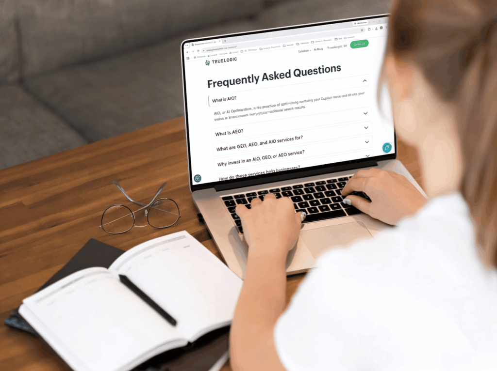Woman reading frequently asked questions on a laptop.